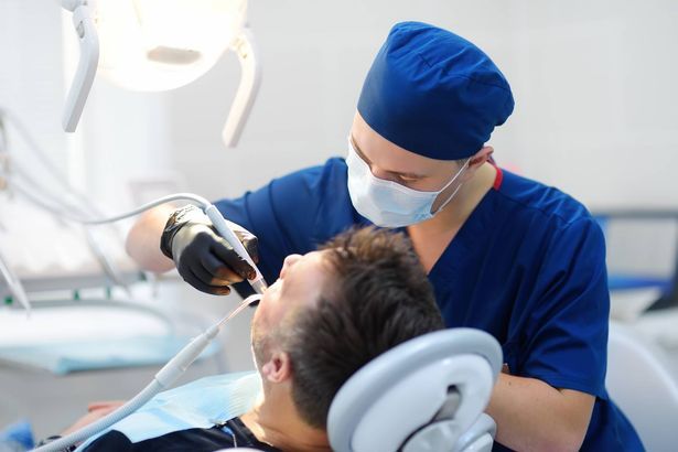 imported-0_Dentist-and-patient-at-medical-center-Doctor-treats-a-mature-man-teeth-with-dental-drill-Orthodont.jpg