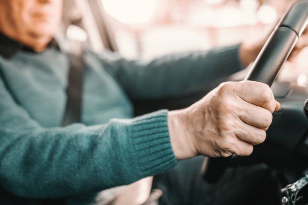 imported-0_Close-up-of-senior-man-holding-hands-on-steering-while-and-driving-his-car.jpg