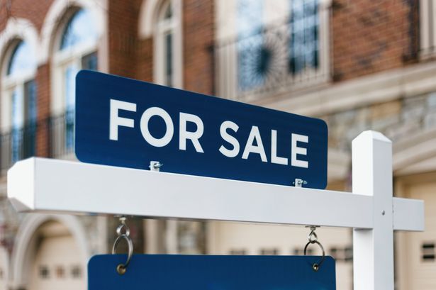 imported-1_For-Sale-Sign-Hangs-in-Front-of-House.jpg