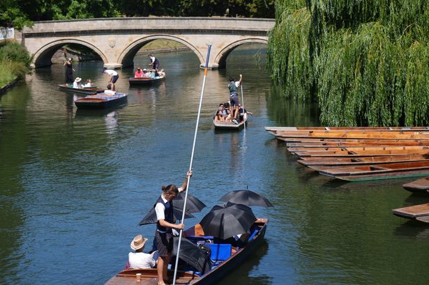 imported-0_People-cover-up-with-umbrellas-as-they-enjoy-the-warm-weather-while-on-the-River-Cam-in-Cambridge-The-UK-will-enter-its.jpg