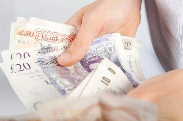 imported-1_A-man-counting-various-denominations-of-UK-pound-notes.jpg