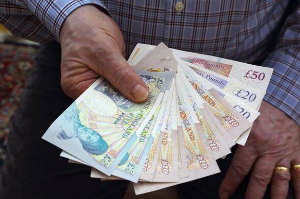 imported-1_Pensioner-holding-British-bank-notes-in-right-hand.jpg