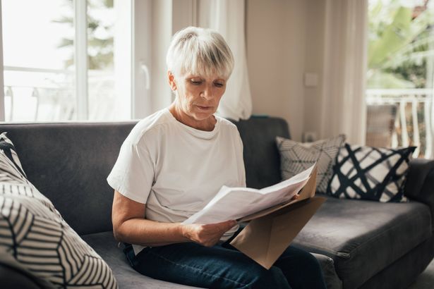imported-0_Grey-haired-Senior-Woman-Reviewing-Paper-Financial-Statements-and-Bills-at-home-Life-on-retirement.jpg