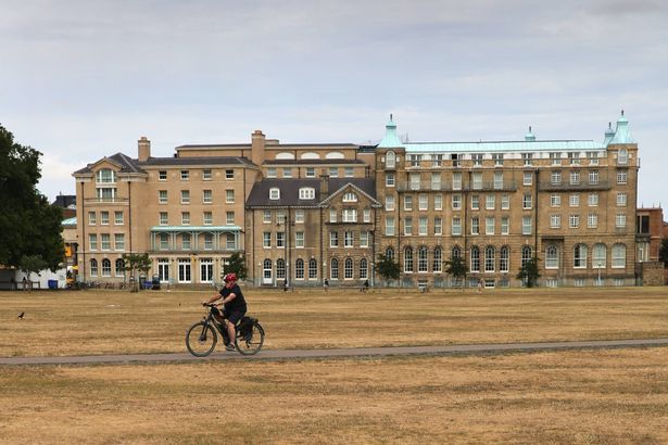 imported-0_A-cyclist-crosses-Parkers-Piece-beside-the-brown-water.jpg
