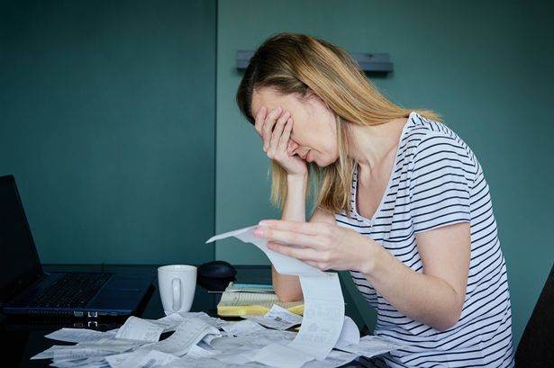 imported-0_Woman-Calculating-Payment-Bill-In-Kitchen.jpg