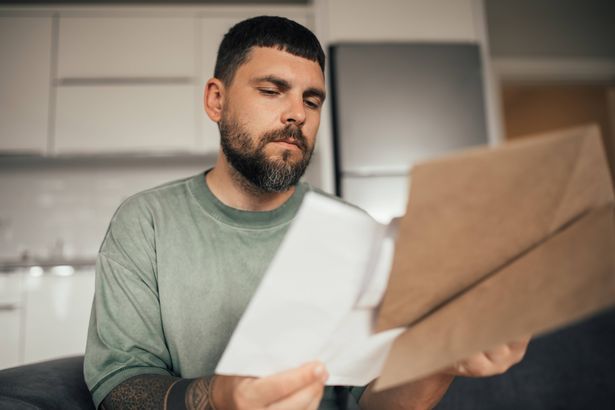 imported-0_Serious-and-concentrated-Man-Reviewing-Paper-Financial-Statements-at-kitchen.jpg