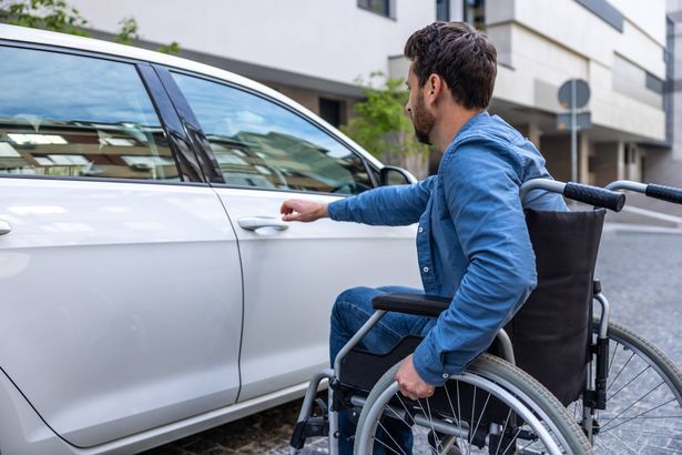 imported-0_Man-in-a-wheelchair-opening-a-car-door.jpg