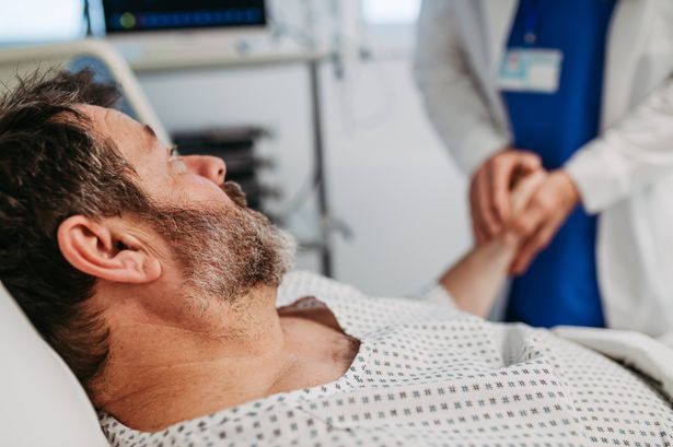 imported-0_Doctor-is-comforting-patient-in-hospital-bed-holding-his-hand.jpg