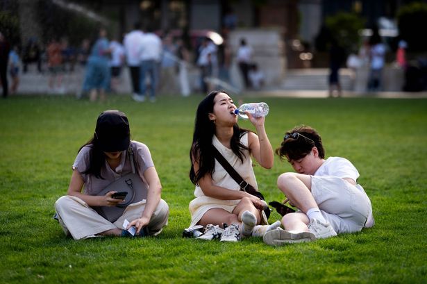 imported-0_A-person-drinks-water-at-Parliament-Square-central-London-The-UK-is-set-to-bake-in-record-breaking-temperatures-which.jpg