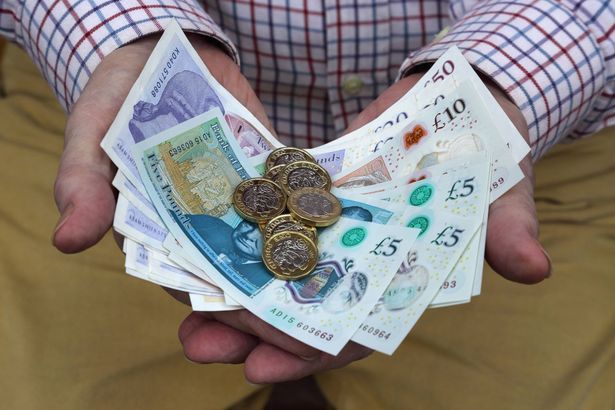imported-0_Pound-coins-and-British-pound-notes-in-mans-hands.jpg