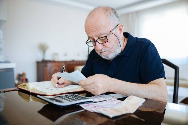 imported-0_Anxious-senior-man-managing-finances-holding-cash-and-using-calculator-at-home.jpg