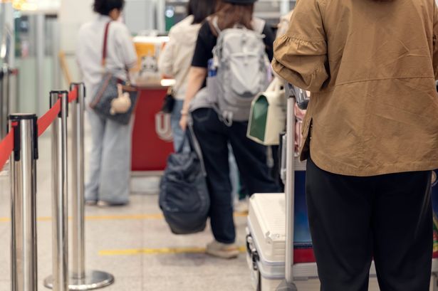imported-0_Passengers-lined-up-at-the-airport-to-check-in-their-luggage.jpg