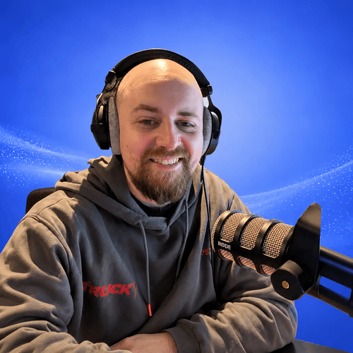 Smiling Podcaster with RØDE Microphone.png